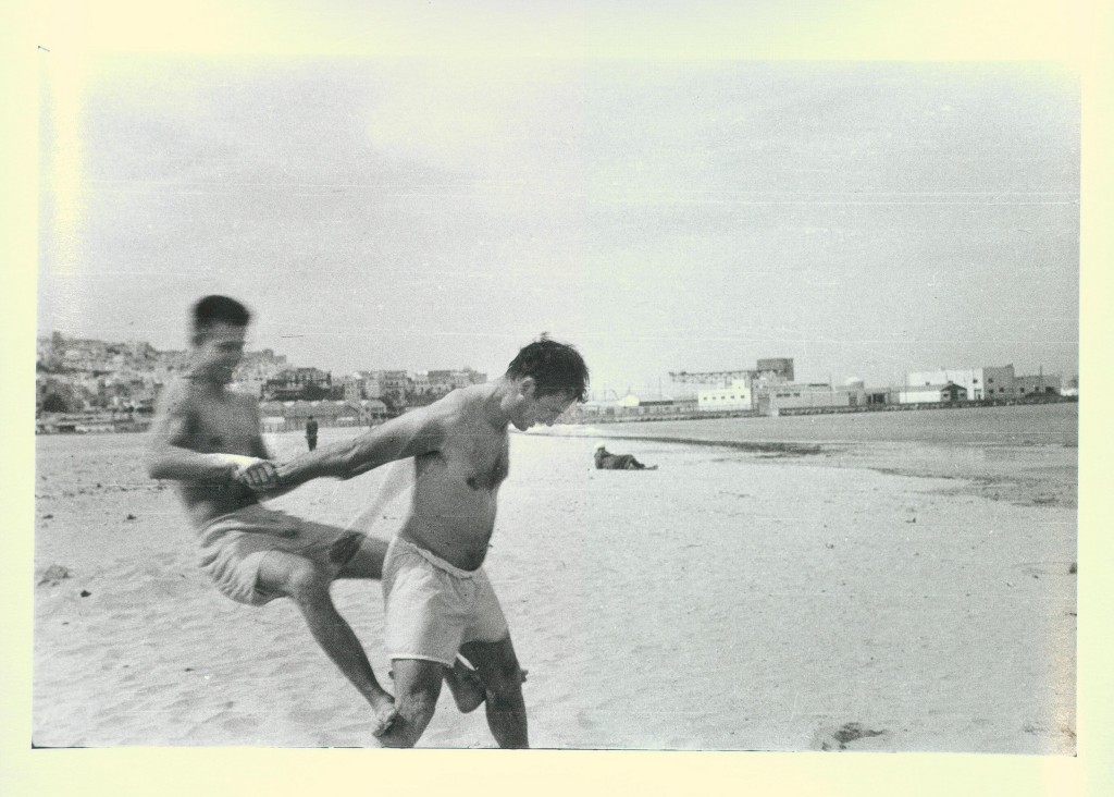 Jack Kerouac and Peter Orlovsky horsing around on the beach, Tangier